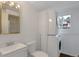 Bathroom featuring a combined toilet/laundry area, modern sink, and shower at 2493 S Kalispell Cir, Aurora, CO 80013