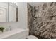 Elegant bathroom with a marble-tiled shower, modern fixtures, and a sleek vanity at 2493 S Kalispell Cir, Aurora, CO 80013