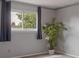 Cozy bedroom with neutral walls and a view of trees outside the window at 2493 S Kalispell Cir, Aurora, CO 80013