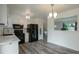 Bright kitchen with white cabinets, black appliances, and modern lighting at 2493 S Kalispell Cir, Aurora, CO 80013