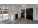Modern kitchen featuring white cabinets, black appliances, and a view to a patio at 2493 S Kalispell Cir, Aurora, CO 80013