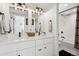 Well-lit bathroom featuring dual sinks, sleek countertops, and a shower-tub combination at 1299 Newton St, Denver, CO 80204