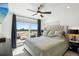 Bedroom with balcony access, ceiling fan, and night stands at 1299 Newton St, Denver, CO 80204