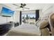 Bedroom with balcony access, ceiling fan, and TV at 1299 Newton St, Denver, CO 80204
