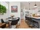 Bright dining area with a modern table set and views into the adjacent kitchen and staircase at 1299 Newton St, Denver, CO 80204