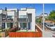 Exterior view of home with fenced yard, patio, and balcony at 1299 Newton St, Denver, CO 80204