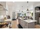 Modern kitchen with stainless steel appliances and spacious island, perfect for cooking and entertaining at 1299 Newton St, Denver, CO 80204