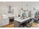Modern kitchen featuring white cabinets, stainless steel appliances, and eat-in island at 1299 Newton St, Denver, CO 80204