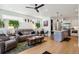 Open-concept living room featuring hardwood floors, modern decor, and a stylish kitchen at 1299 Newton St, Denver, CO 80204