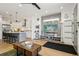 Bright living space with hardwood floors, kitchen island, and TV area with gray wood paneling at 1299 Newton St, Denver, CO 80204