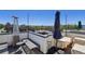 Rooftop deck with seating, umbrella, and city view at 1299 Newton St, Denver, CO 80204