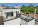 Aerial view of rooftop deck with patio seating and city view at 1299 Newton St, Denver, CO 80204