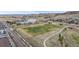 Aerial view of community park with soccer field and recreation center in a neighborhood with houses at 10204 Ridgegate Cir, Lone Tree, CO 80124