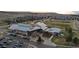 This aerial view shows community buildings, trees, walkways, and lots of parking spaces at 10204 Ridgegate Cir, Lone Tree, CO 80124