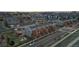 Aerial view showcasing a residential neighborhood with townhomes, streets and some commercial buildings in the background at 10204 Ridgegate Cir, Lone Tree, CO 80124