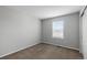 Empty bedroom with neutral walls and floors, and a window providing natural light at 10204 Ridgegate Cir, Lone Tree, CO 80124