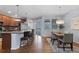 Modern kitchen featuring a breakfast bar, stainless steel appliances, and an adjacent dining area at 10204 Ridgegate Cir, Lone Tree, CO 80124