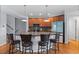 Modern kitchen featuring an island with bar seating, stainless steel appliances, and wooden cabinets at 10204 Ridgegate Cir, Lone Tree, CO 80124