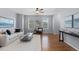 Bright living room with hardwood floors, a plush rug, and windows letting in natural light at 10204 Ridgegate Cir, Lone Tree, CO 80124