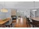 Open concept kitchen and living space featuring fireplace, island with seating, and hardwood floors at 10204 Ridgegate Cir, Lone Tree, CO 80124