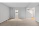 Spacious room with neutral walls, plush carpeting, and a view of the upper level via stairs at 10204 Ridgegate Cir, Lone Tree, CO 80124