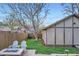 Relaxing backyard setting with a fire pit, comfortable seating, and mature trees providing shade at 2039 S Corona St, Denver, CO 80210
