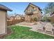 Charming backyard with a fire pit, Adirondack chairs, lush lawn, and mature trees at 2039 S Corona St, Denver, CO 80210