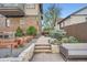 Inviting backyard featuring a stone patio, built-in seating, and lush landscaping at 2039 S Corona St, Denver, CO 80210