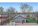 Balcony view overlooking a fenced backyard and detached garage, enhanced by potted plants at 2039 S Corona St, Denver, CO 80210