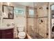 Updated bathroom featuring a walk-in shower with beautiful tile work and pebble flooring at 2039 S Corona St, Denver, CO 80210