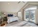 Bright bedroom with a balcony, natural light, and carpeted floors at 2039 S Corona St, Denver, CO 80210