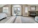 Sunlit bedroom with balcony access, a fireplace, neutral walls, and carpeted floors at 2039 S Corona St, Denver, CO 80210