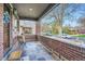 Inviting front porch featuring brick accents, slate flooring, and neighborhood views at 2039 S Corona St, Denver, CO 80210