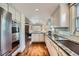 Modern kitchen with stainless steel appliances and open to a cozy seating area at 2039 S Corona St, Denver, CO 80210