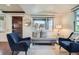 Cozy living room with two chairs, daybed, hardwood floors, and natural light at 2039 S Corona St, Denver, CO 80210