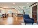 Spacious living room featuring hardwood floors, staircase, and dark wood accents throughout at 2039 S Corona St, Denver, CO 80210