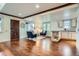 Open-concept living room featuring hardwood floors, natural light, and kitchenette at 2039 S Corona St, Denver, CO 80210