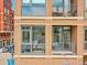 Balcony with view of building with blue awning and other units at 2100 16Th St # 204, Denver, CO 80202