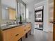 Modern bathroom featuring a double vanity, sleek fixtures, and view from the window at 2100 16Th St # 204, Denver, CO 80202