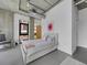 Modern bedroom features exposed ductwork, large window and concrete pillars at 2100 16Th St # 204, Denver, CO 80202