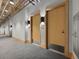 Hallway with carpet and gray walls, with access to units through light wooden doors at 2100 16Th St # 204, Denver, CO 80202