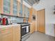 Bright kitchen featuring stainless steel appliances, wooden cabinetry, and modern design elements at 2100 16Th St # 204, Denver, CO 80202