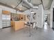 Modern kitchen and dining area with island, stainless steel appliances, and concrete ceiling at 2100 16Th St # 204, Denver, CO 80202