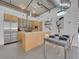 Modern kitchen with stainless steel appliances and an island that opens up to the dining area at 2100 16Th St # 204, Denver, CO 80202