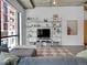 Bright living room features an open floor plan, TV, shelves, and expansive windows at 2100 16Th St # 204, Denver, CO 80202