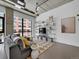 Bright living room features an open floor plan, TV, shelves, and expansive windows at 2100 16Th St # 204, Denver, CO 80202