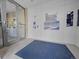 Entryway with a blue mat and glass door, with the building's information on the wall at 2100 16Th St # 204, Denver, CO 80202