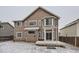 Exterior showcasing a home with neutral siding, a pergola-covered deck and snow-covered backyard at 560 Hampstead Ave, Castle Rock, CO 80104