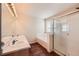 Modern bathroom with double sinks, large mirror, bathtub, and shower stall at 560 Hampstead Ave, Castle Rock, CO 80104