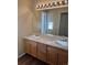 Bathroom boasts double sinks, light wood cabinets, and a large mirror at 560 Hampstead Ave, Castle Rock, CO 80104